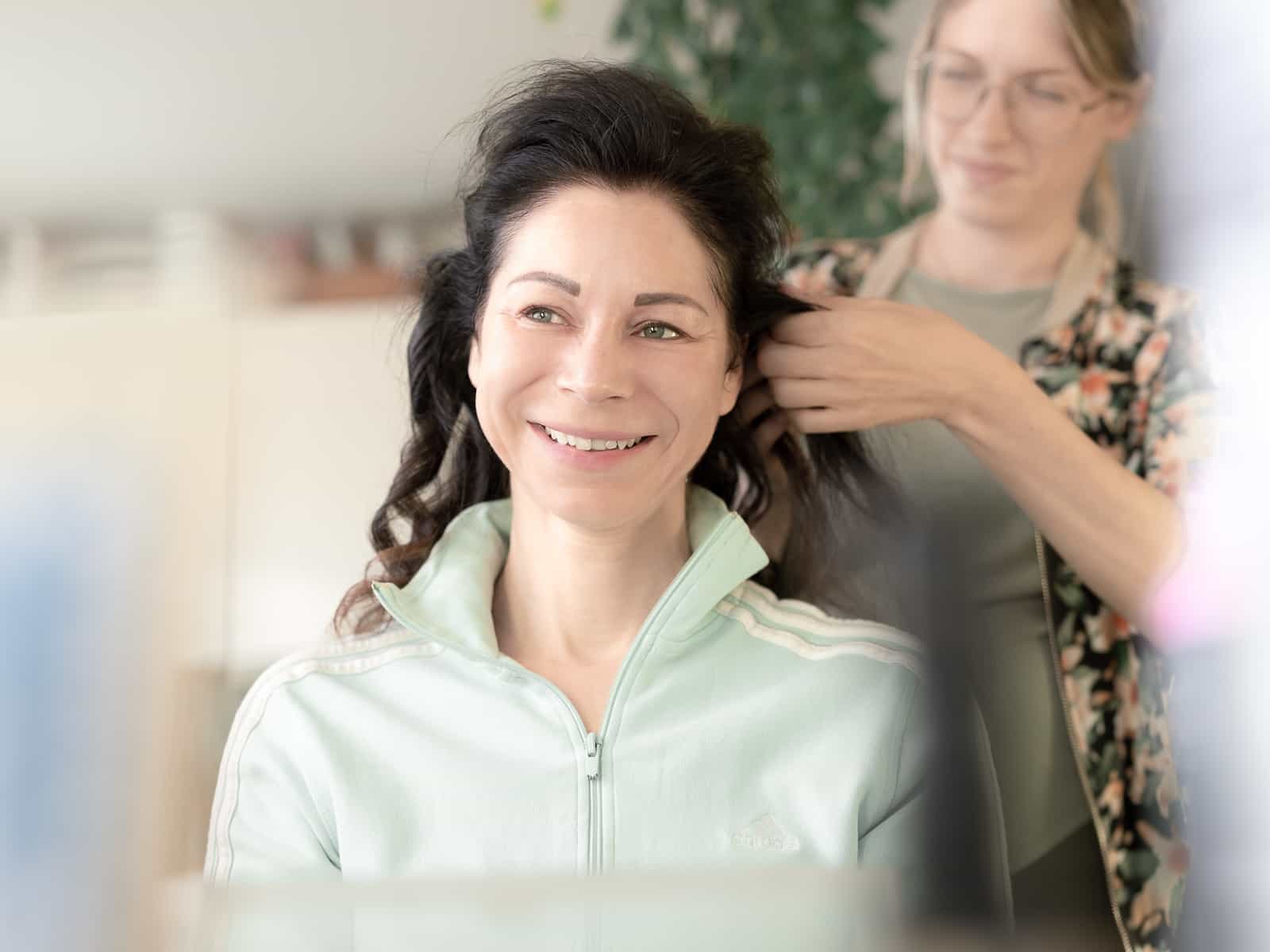 Bride being styled by makeup artist for wedding