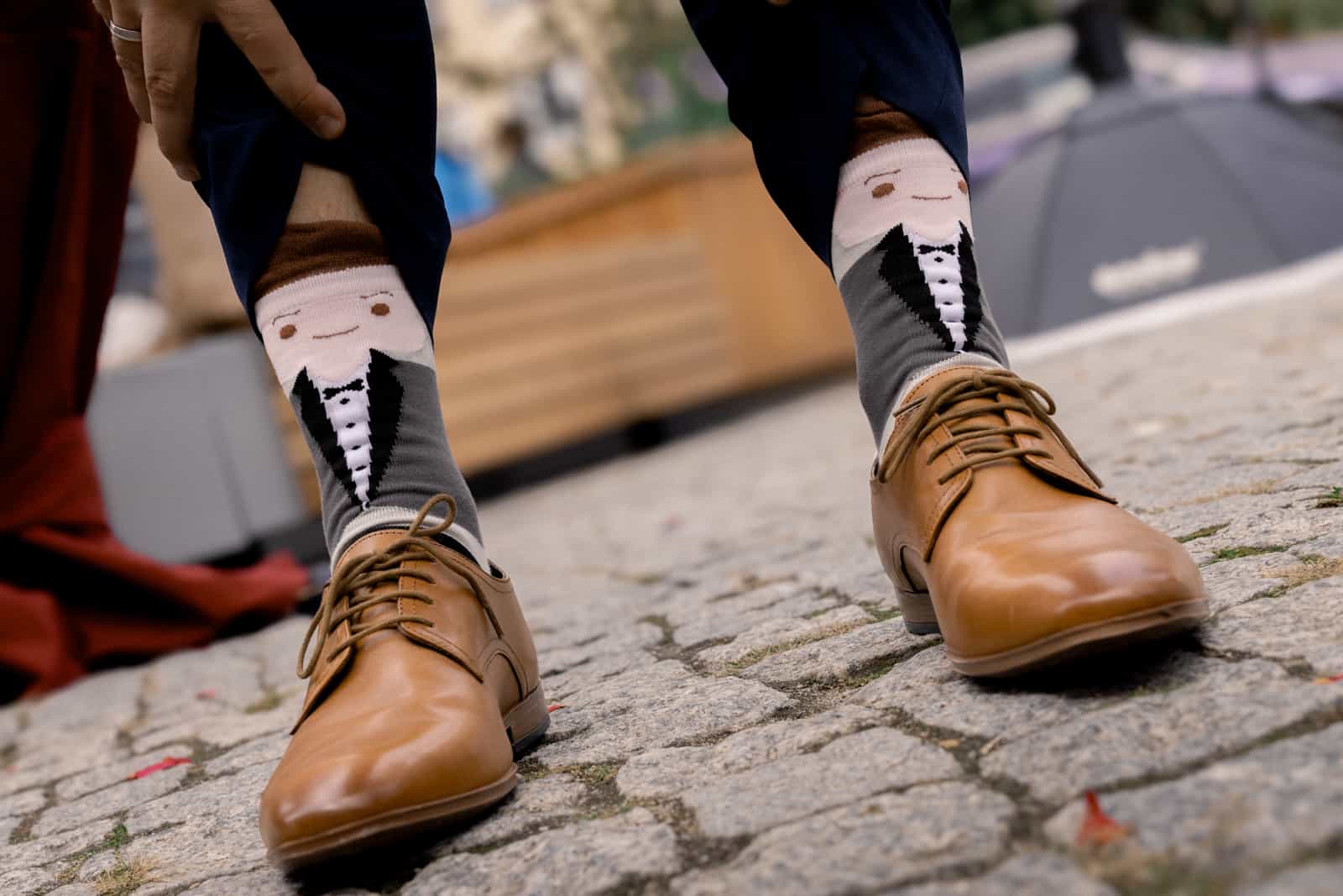 Bride with closed eyes being hugged by two women, champagne, black and white