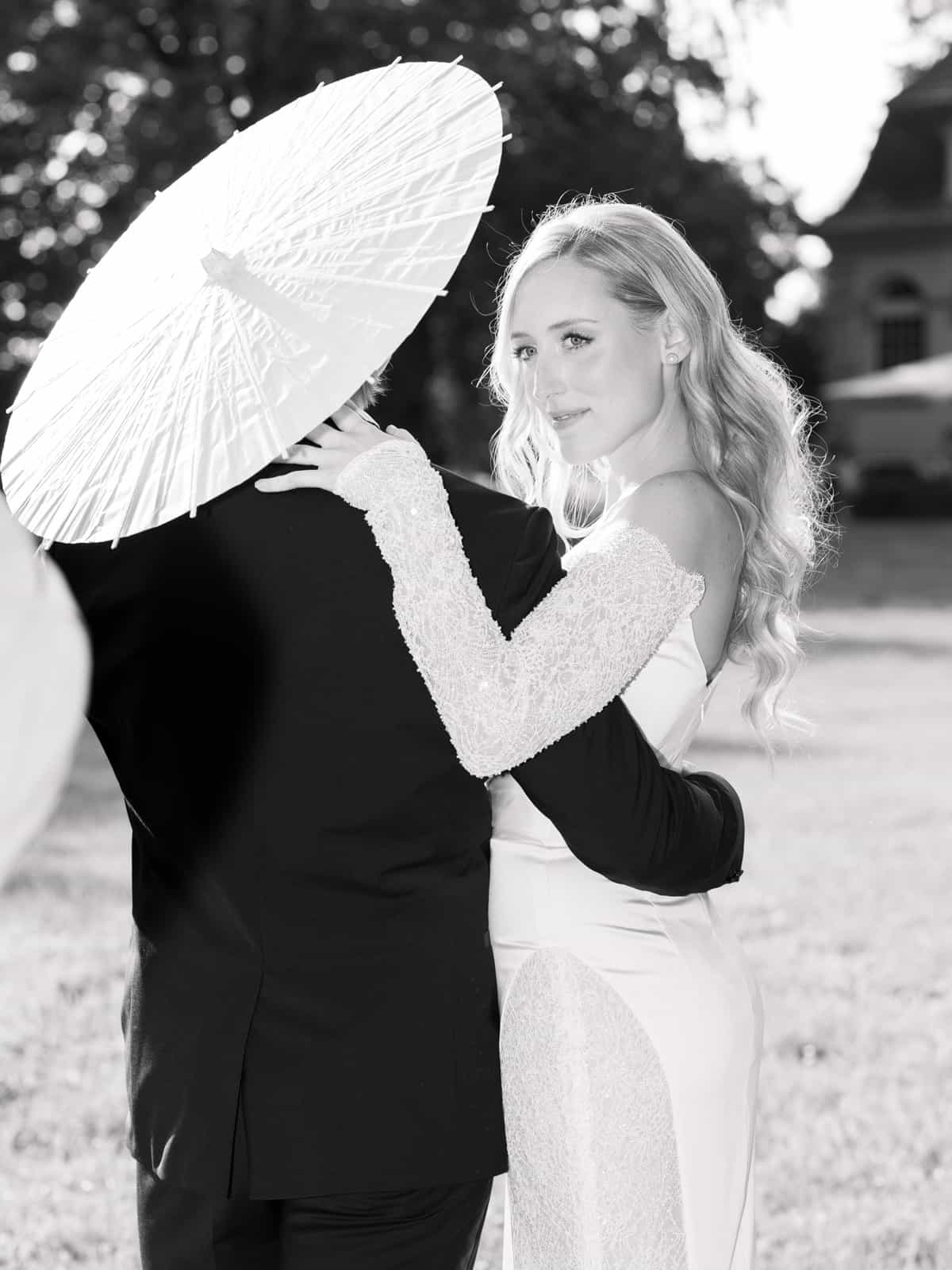 Bride with white parasol and groom at Schloss Kartzow castle wedding