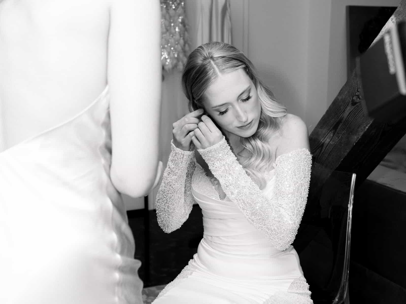 Bride putting on earrings getting ready wedding Schloss Kartzow