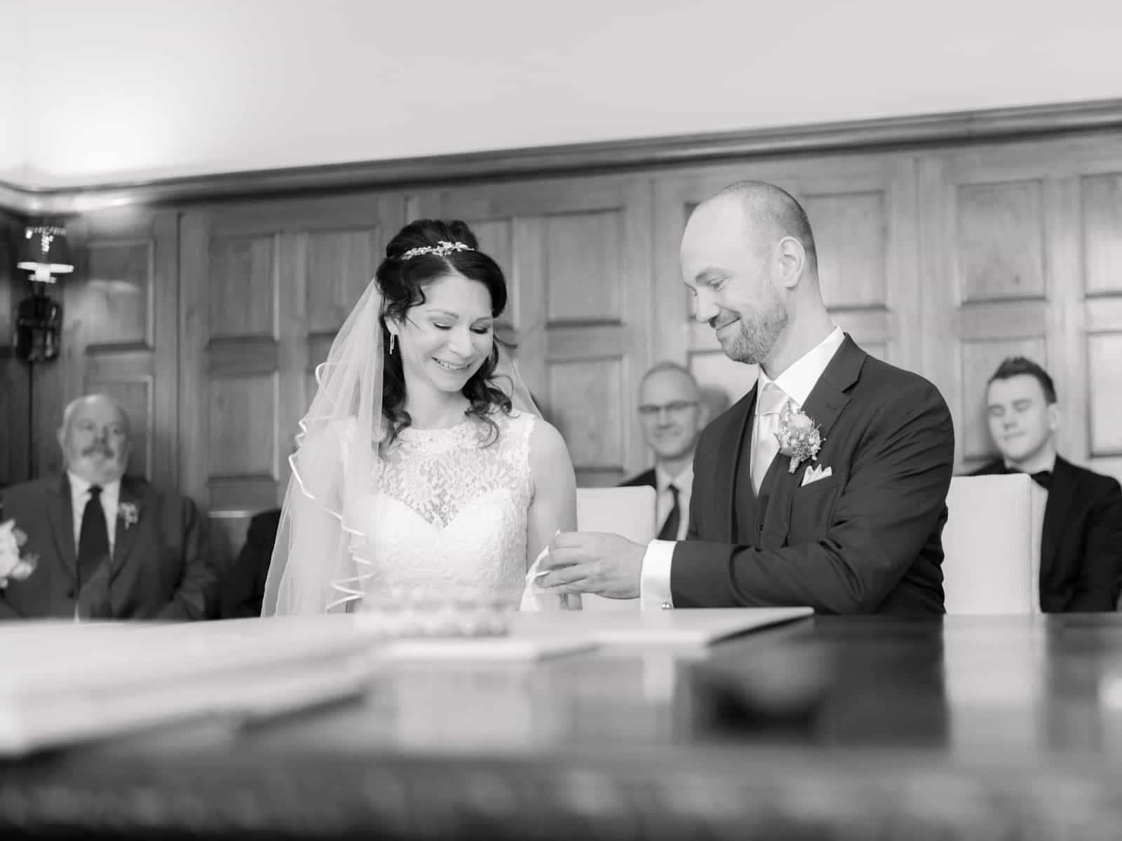 Couple signing marriage certificate at registry office