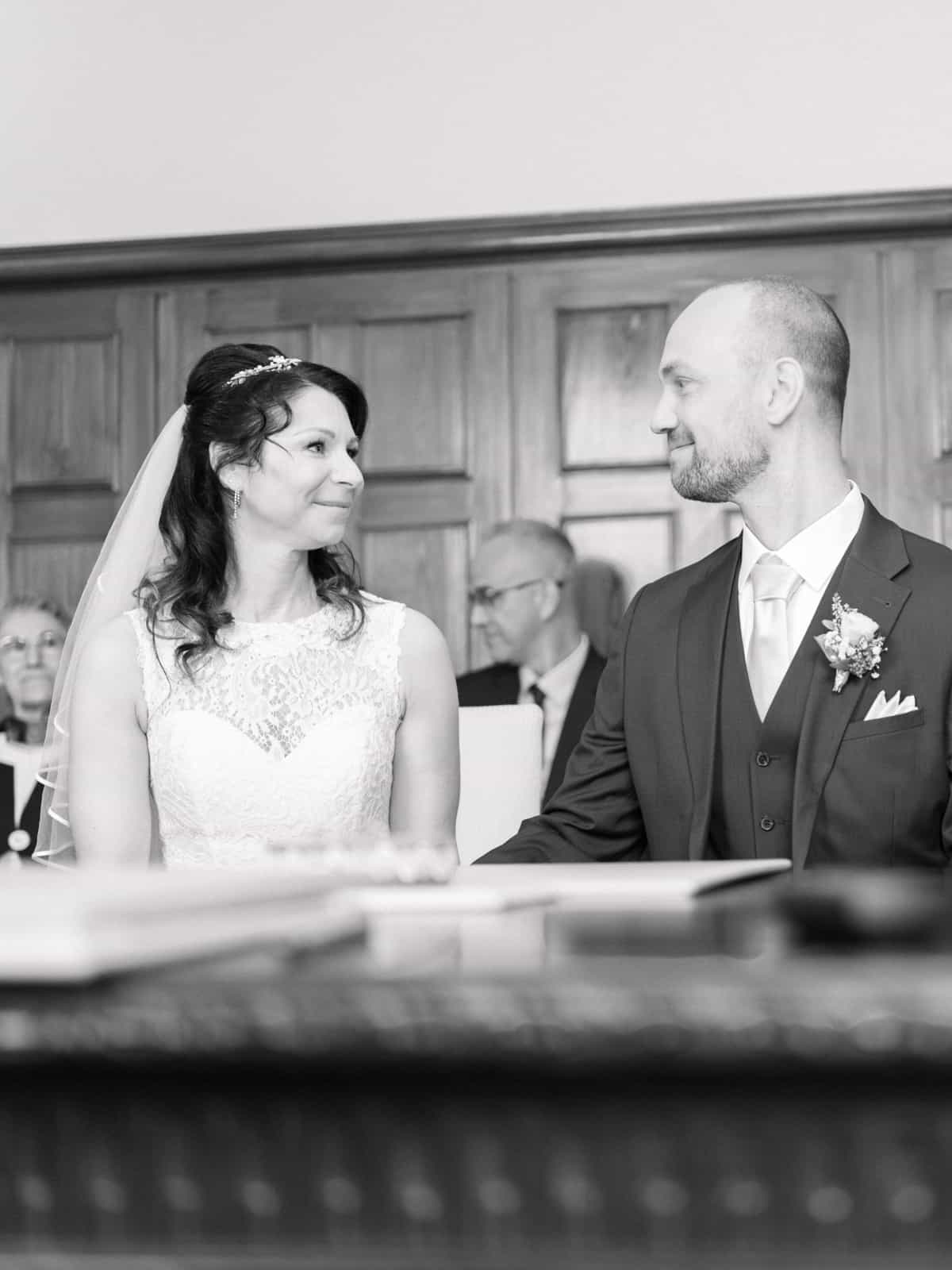 Couple looking lovingly at each other during civil ceremony