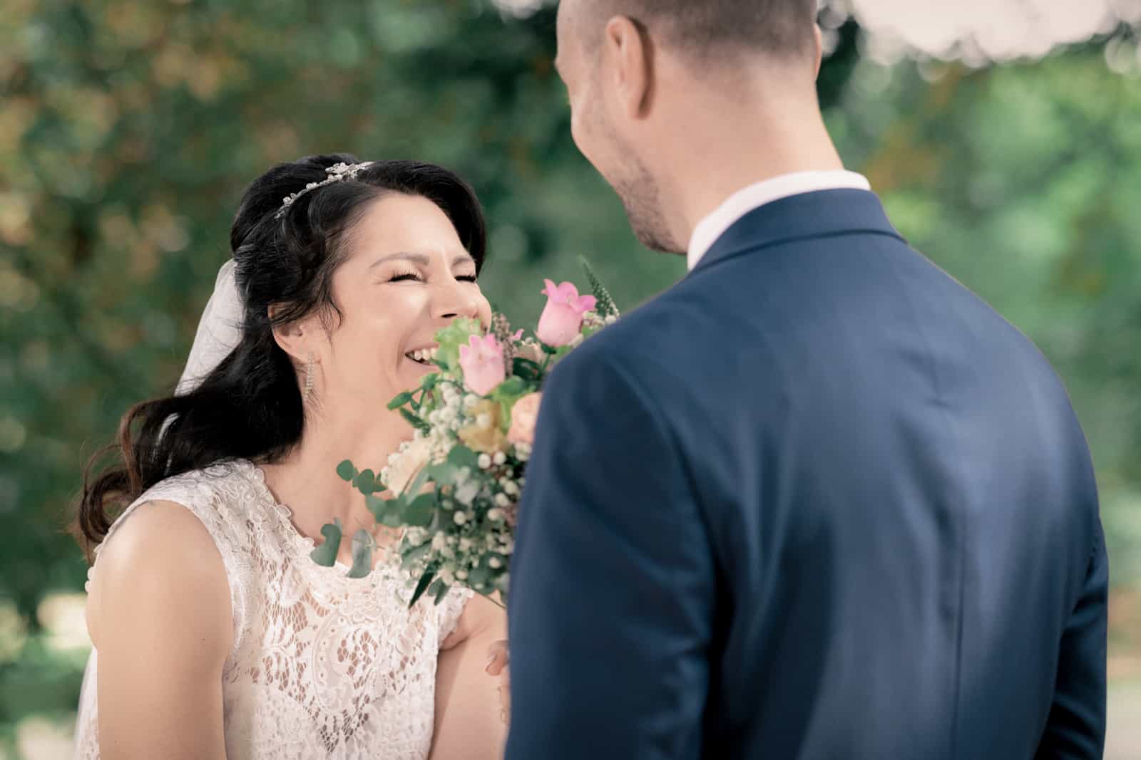 Couple walking hand in hand through avenue with mature trees, black and white