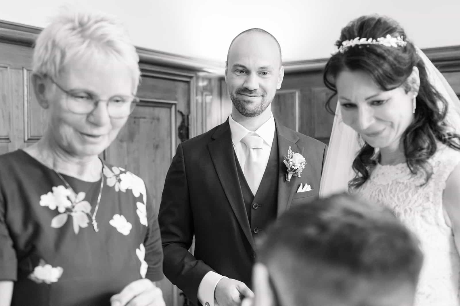 Couple with elderly lady in floral dress, cross-generational, black and white