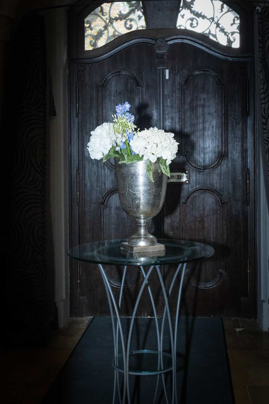 Silver champagne bucket with white hydrangeas and blue delphinium as wedding decoration