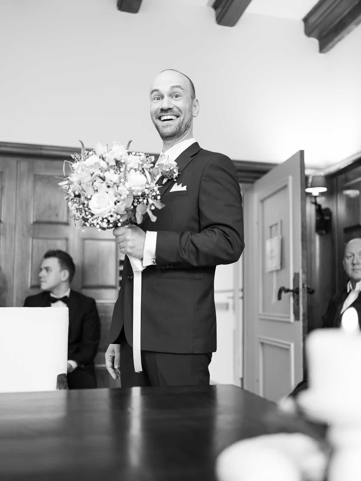 Moved groom wiping away tear