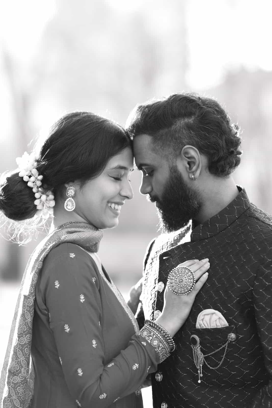 Indian couple forehead to forehead with hand on chest, black and white