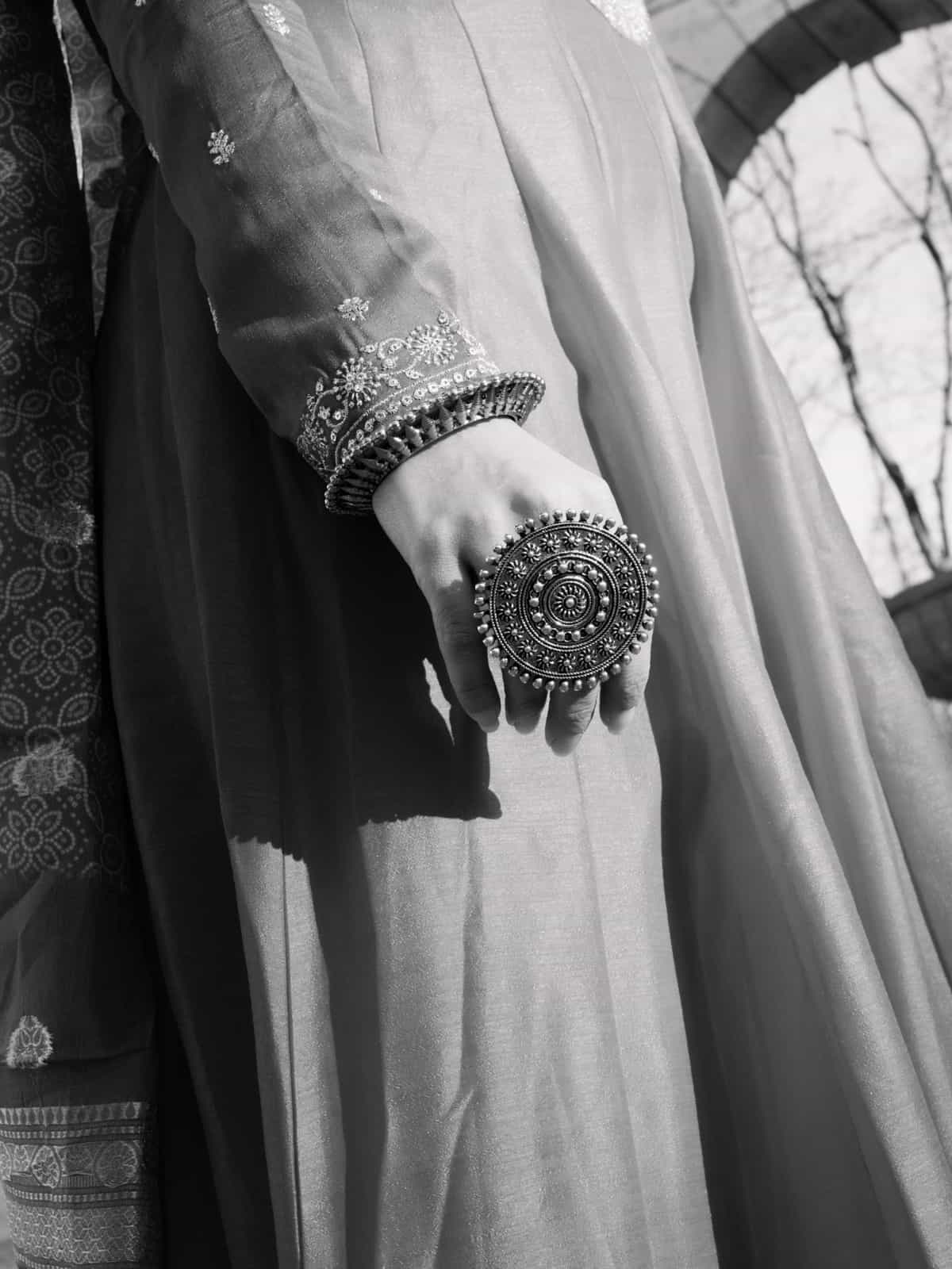 Close-up of traditional Indian gold jewelry and embroidered red fabric