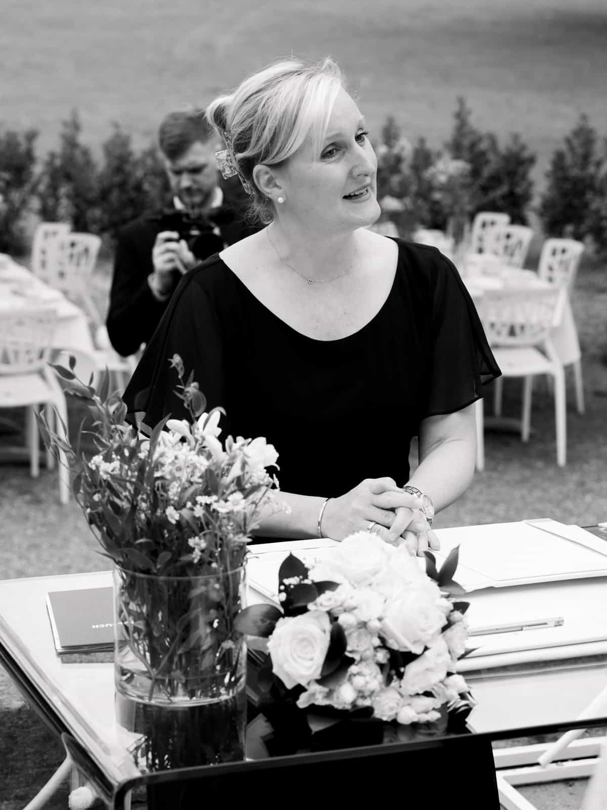 Maid of honor in black dress at wedding ceremony at Schloss Kartzow in black and white