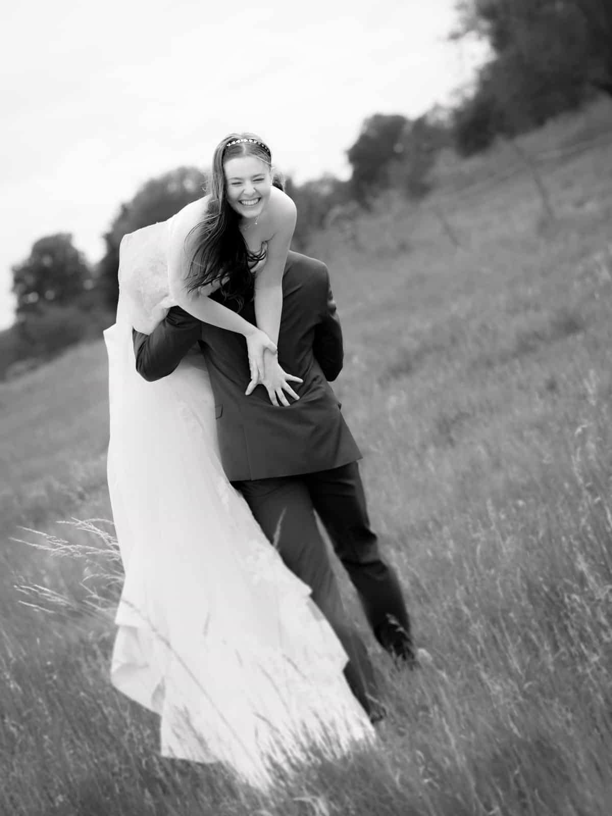 Joyful couple in playful motion on rural path