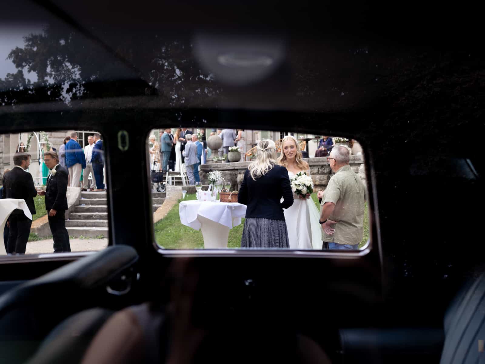 Wedding guests through vintage car window at Schloss Kartzow castle wedding
