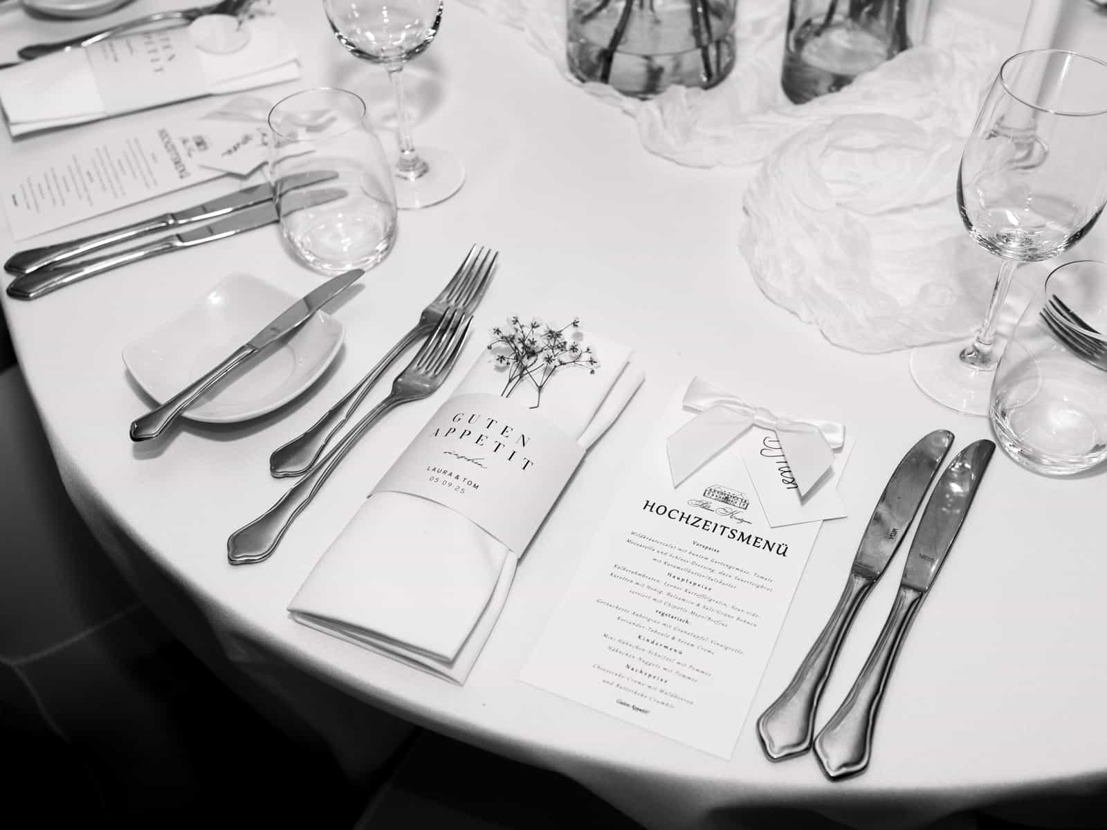 Set wedding table with menu card, cutlery and glasses at Schloss Kartzow wedding, black and white detail shot