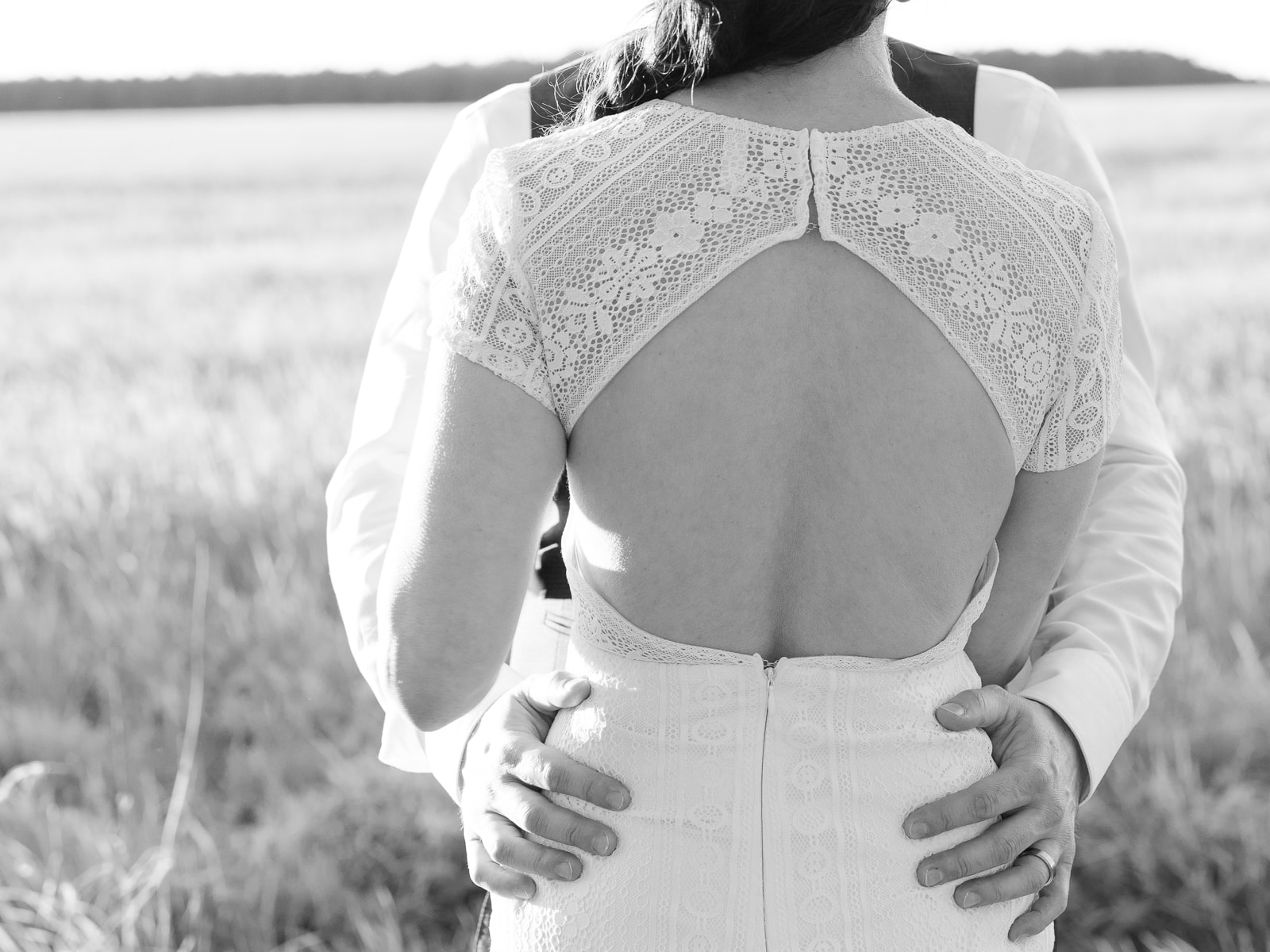 Back view of wedding dress with open back and lace details