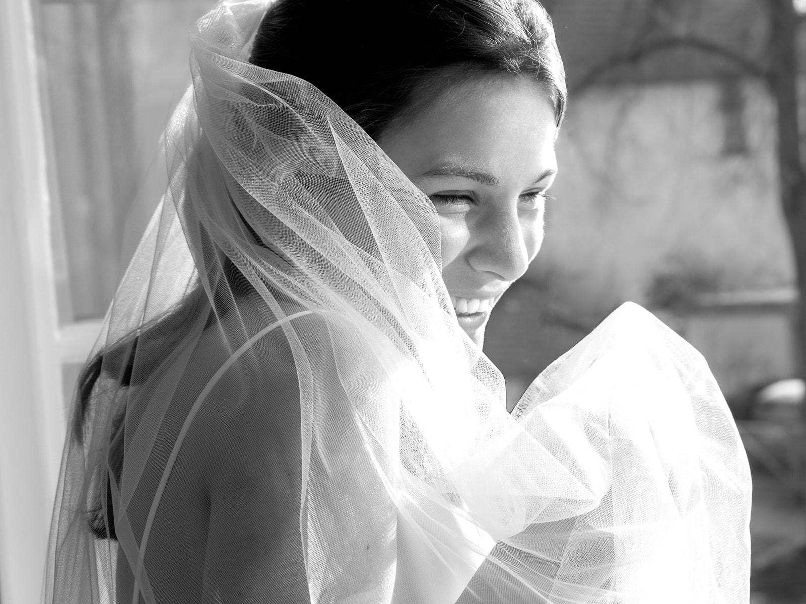 Bride with veil in emotional black and white portrait