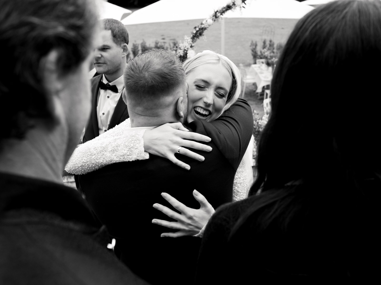Bride embracing guest at Schloss Kartzow wedding, emotional congratulations after outdoor ceremony