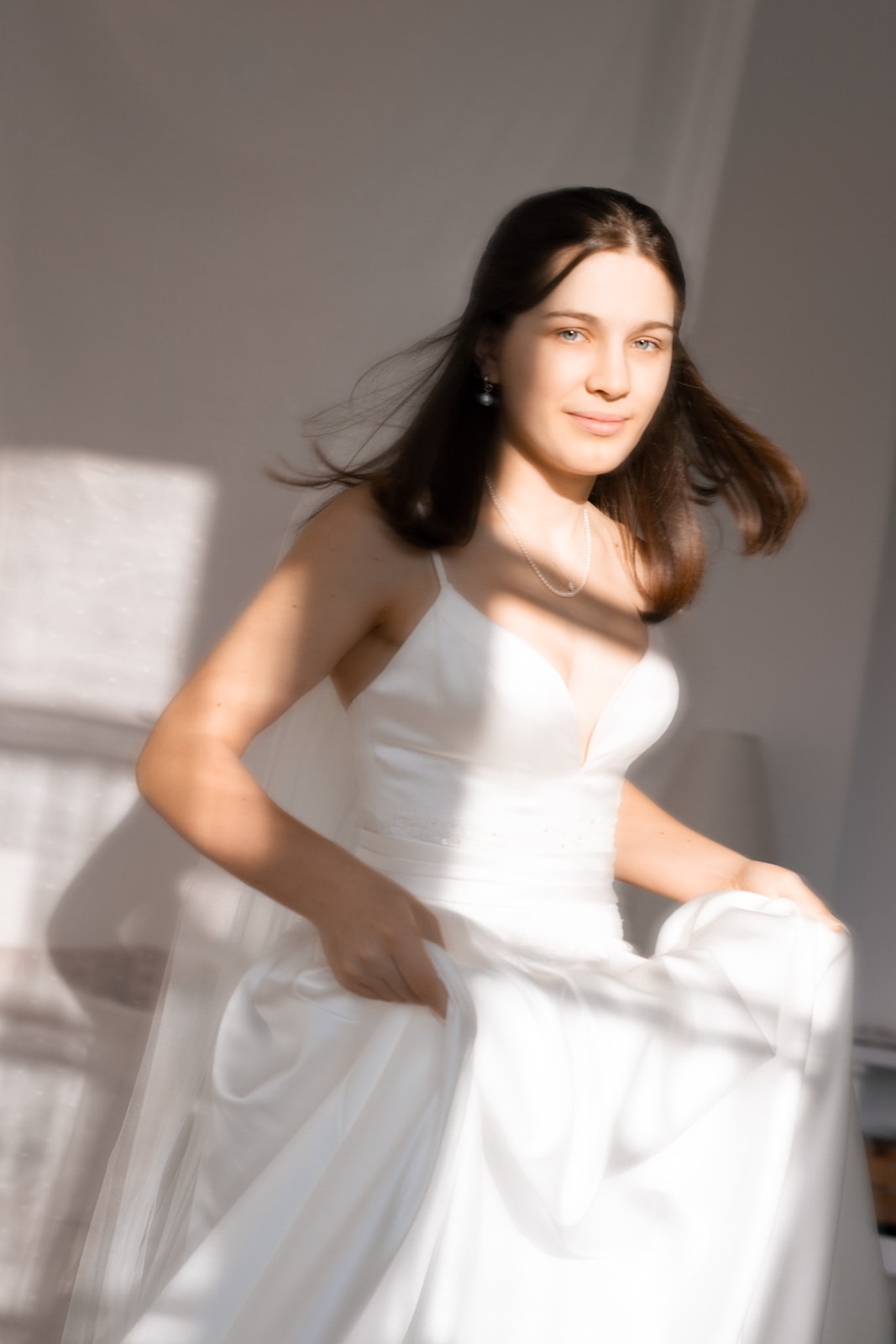Joyful bride in white dress captured in dynamic motion