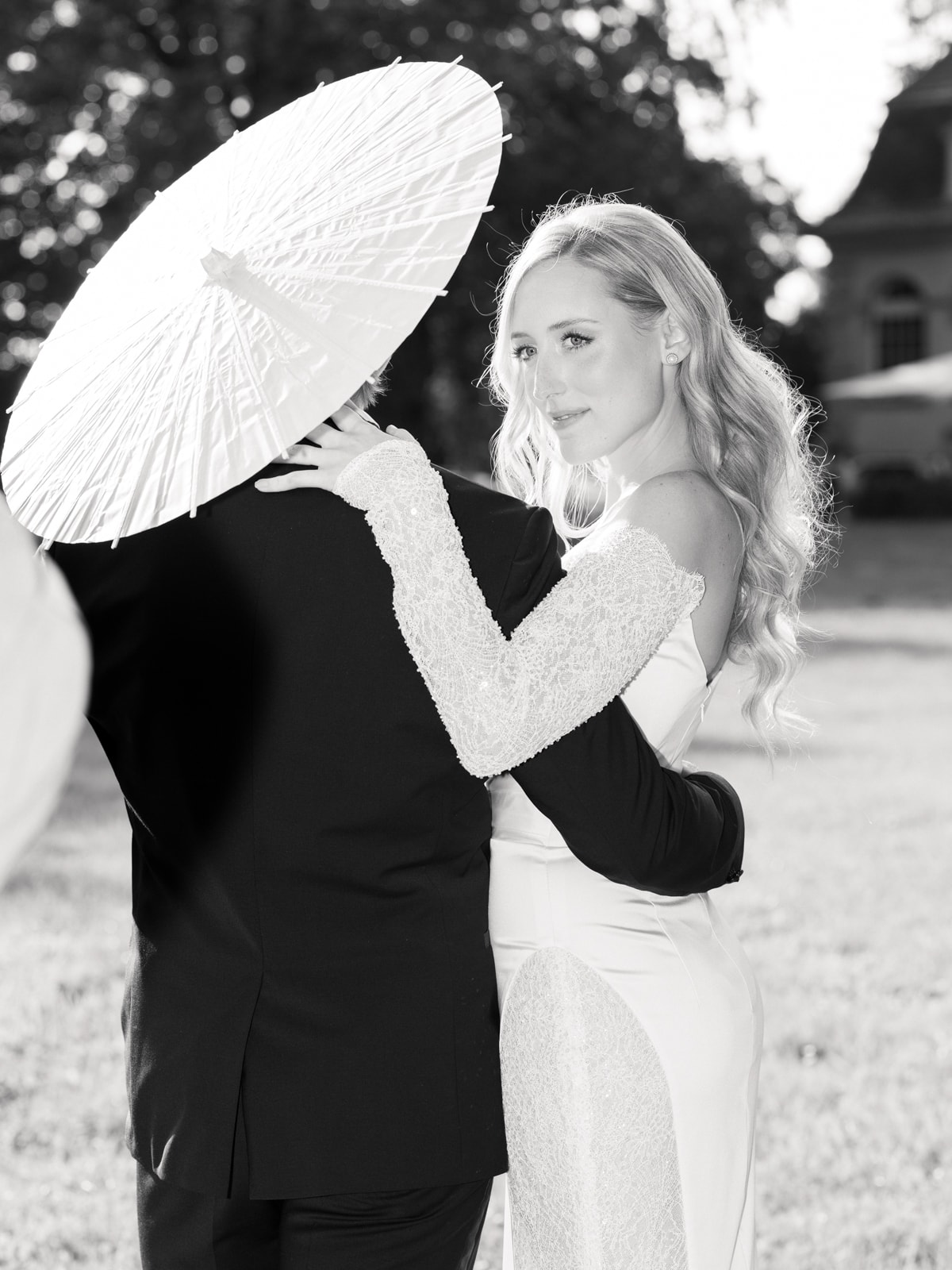 Bride with white parasol and groom at Schloss Kartzow castle wedding