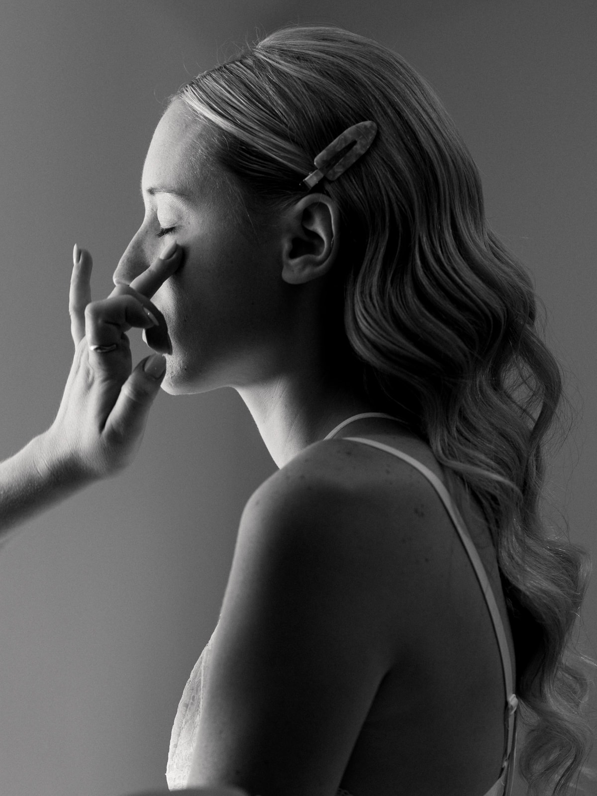 Bride in wedding dress looking aside during getting ready preparations, black and white wedding photography Schloss Kartzow