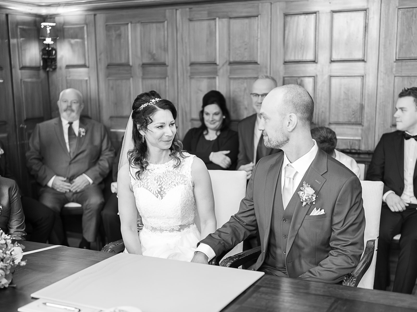 Bridal couple exchanging loving glances during civil ceremony