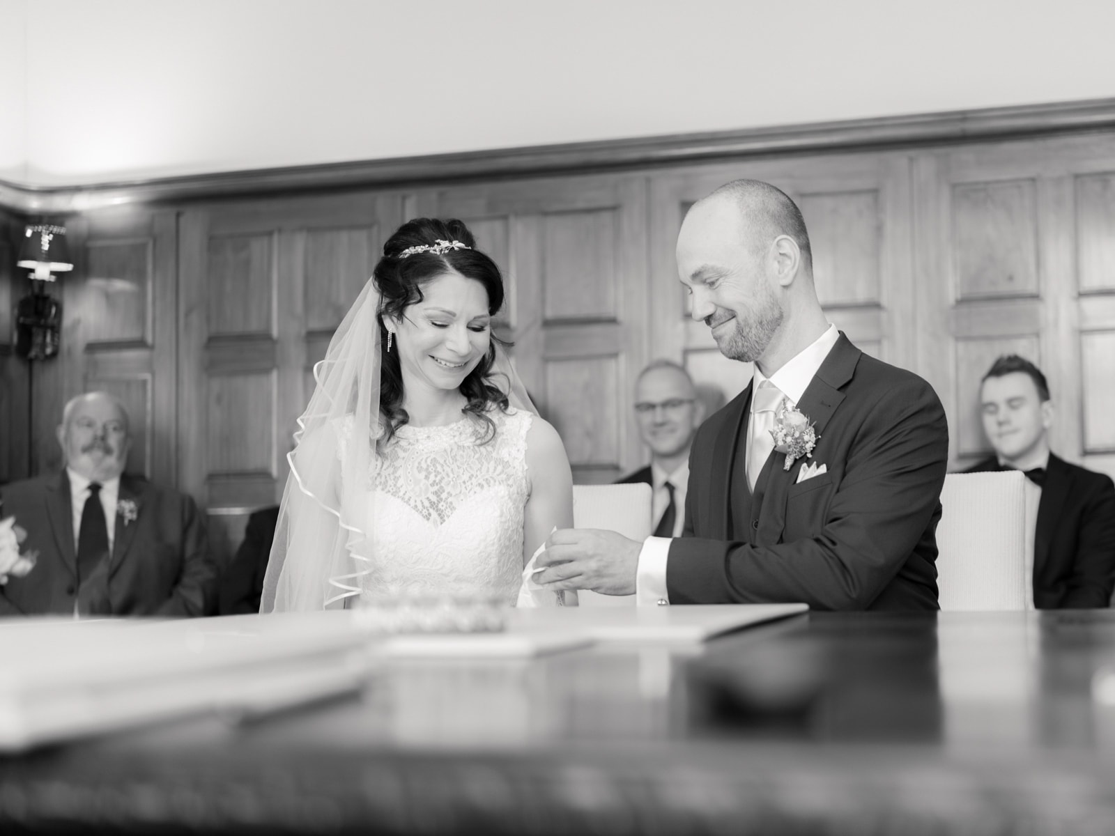 Couple signing marriage certificate at registry office