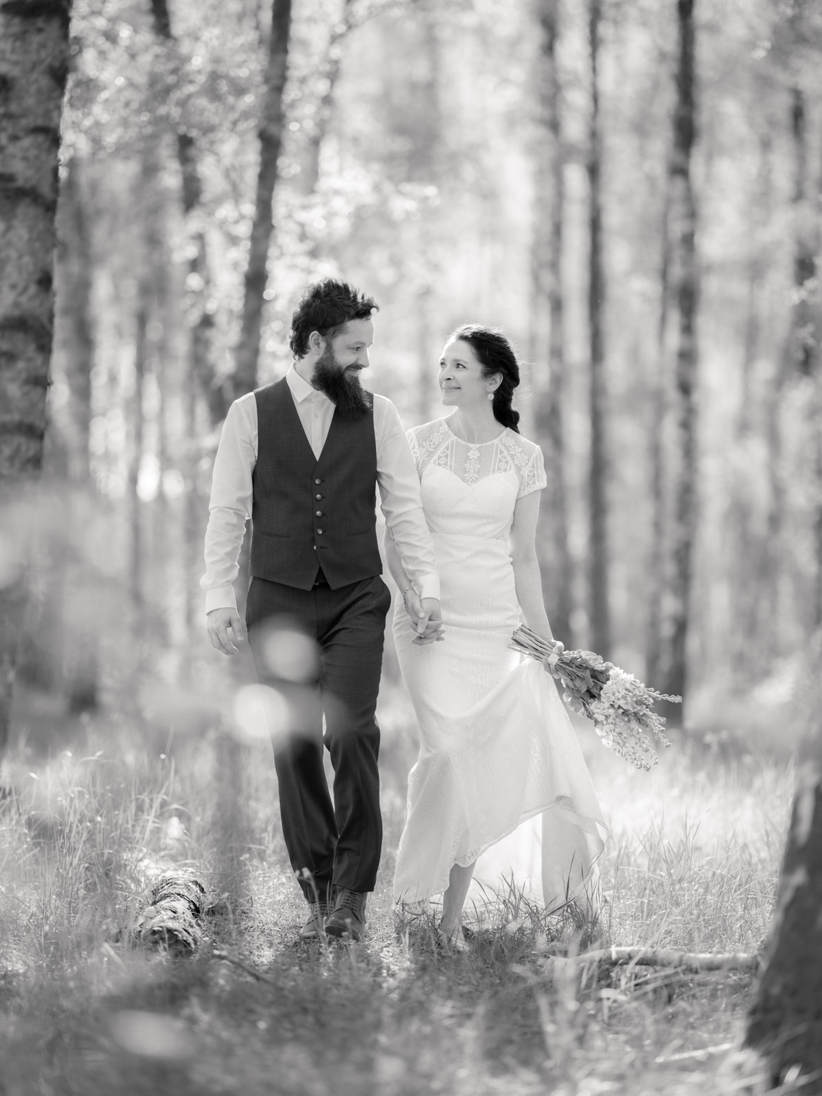 Couple hand in hand in forest in classic black and white photography
