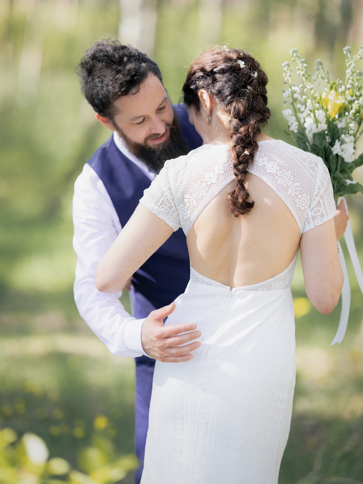 Dreamy couple in tender pose between birch trees