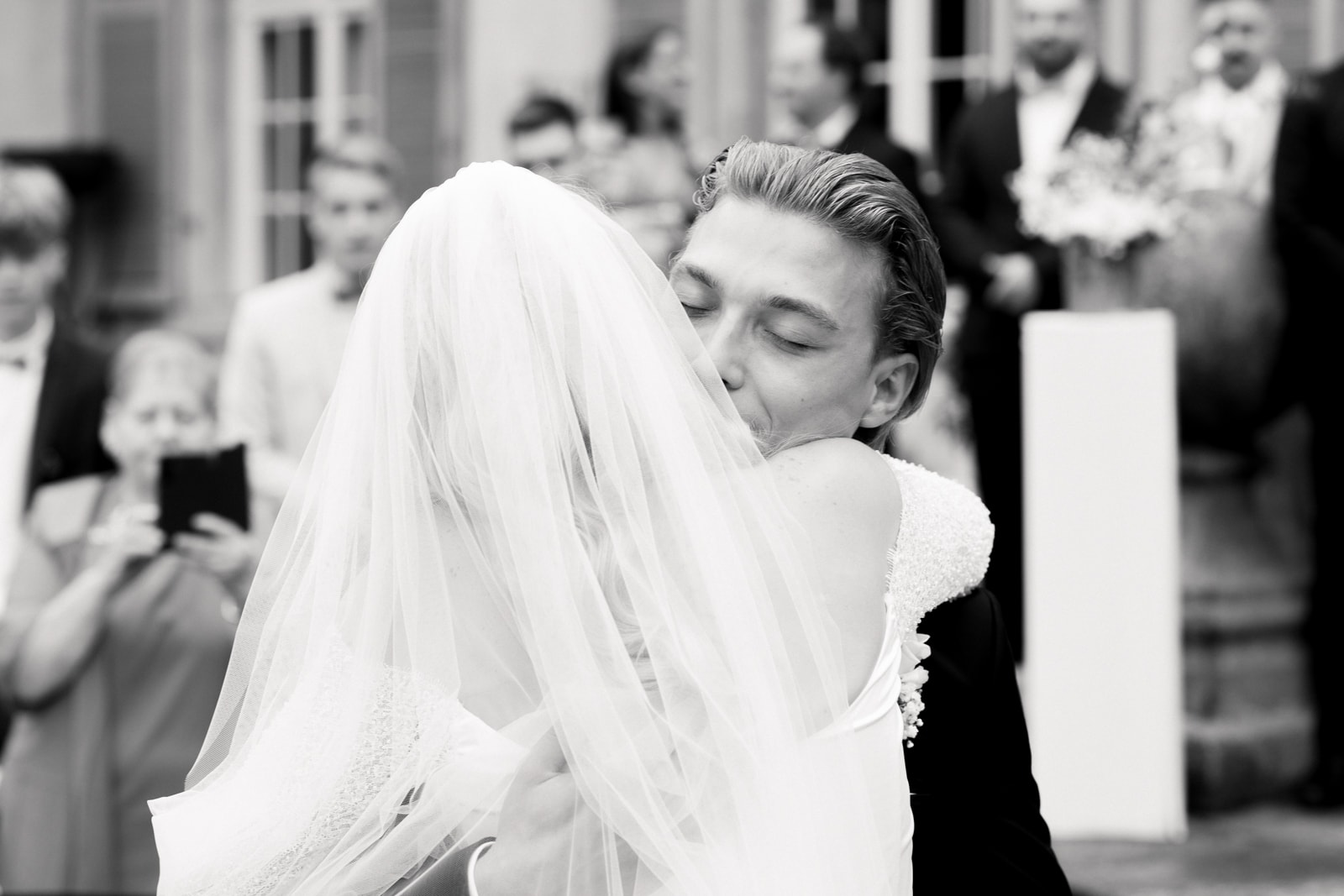 Bride and groom in emotional embrace during wedding ceremony