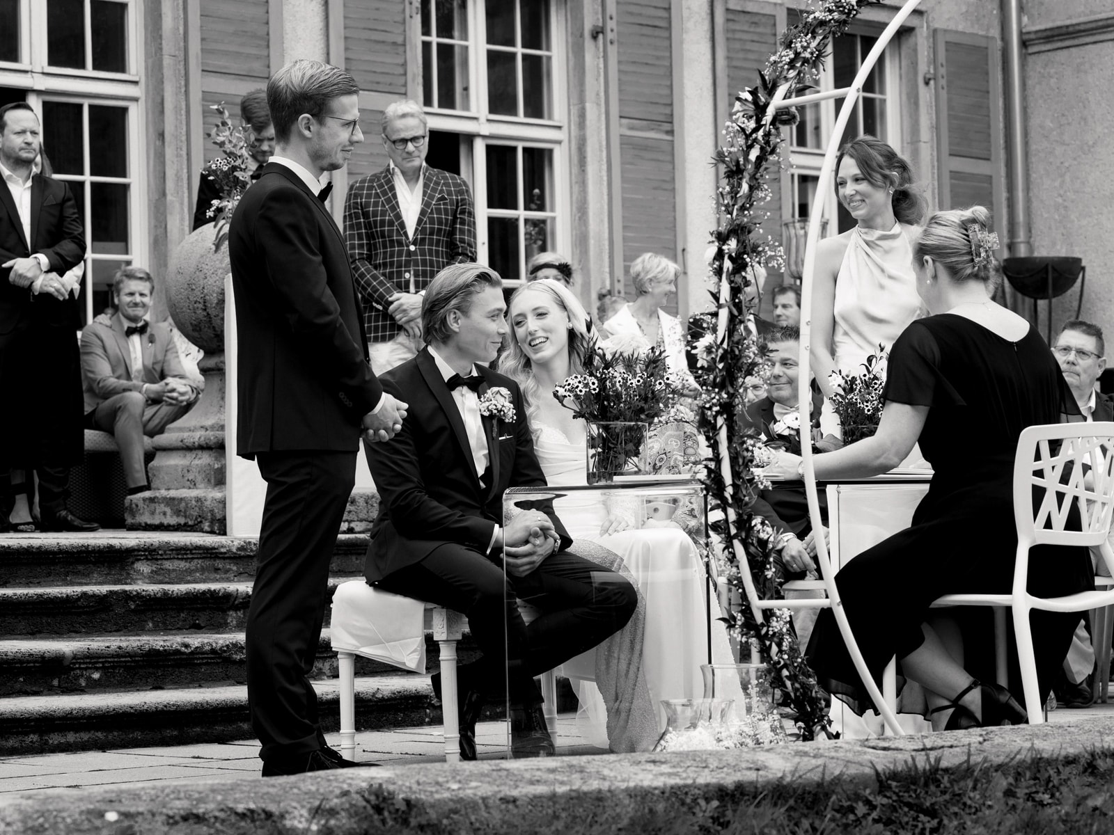 Wedding couple smiling during wedding ceremony at Schloss Kartzow in black and white