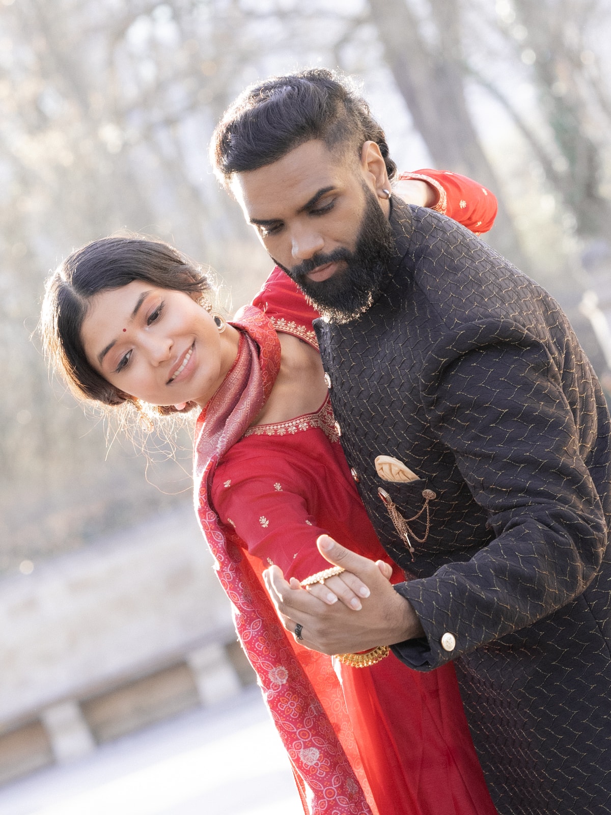 Happy Indian bridal couple in loving embrace in the park