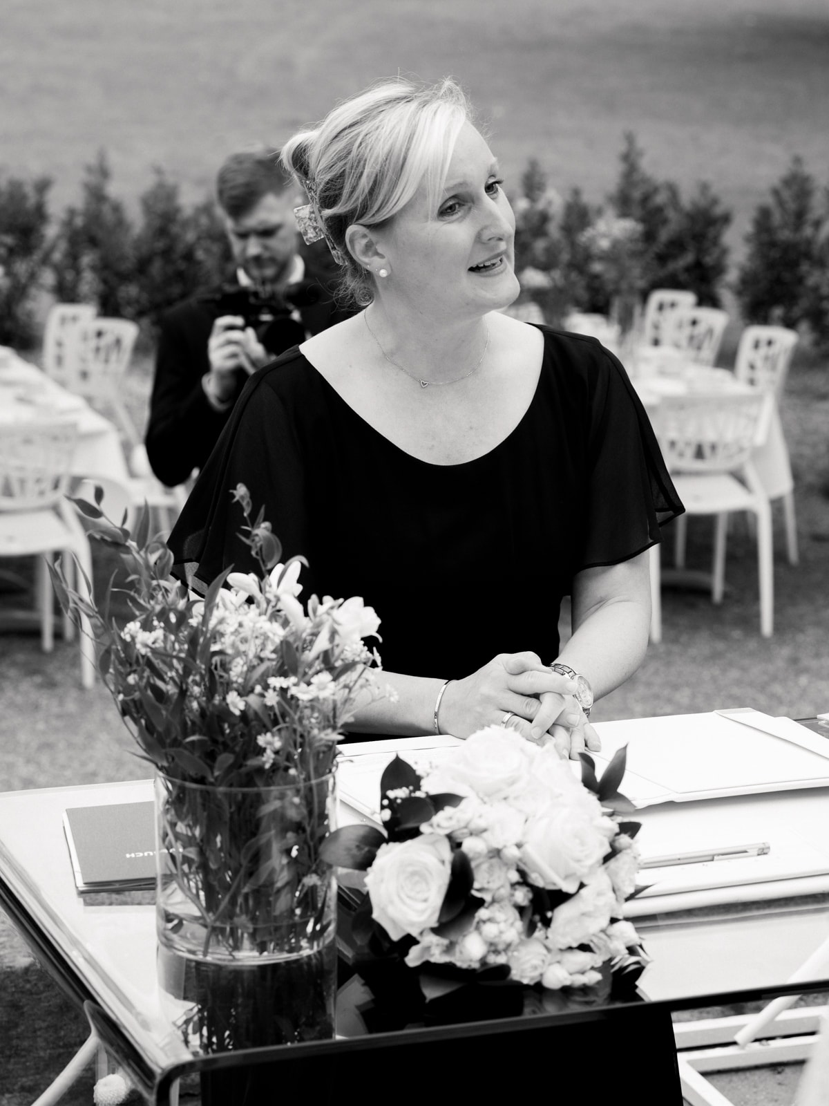 Maid of honor in black dress at wedding ceremony at Schloss Kartzow in black and white
