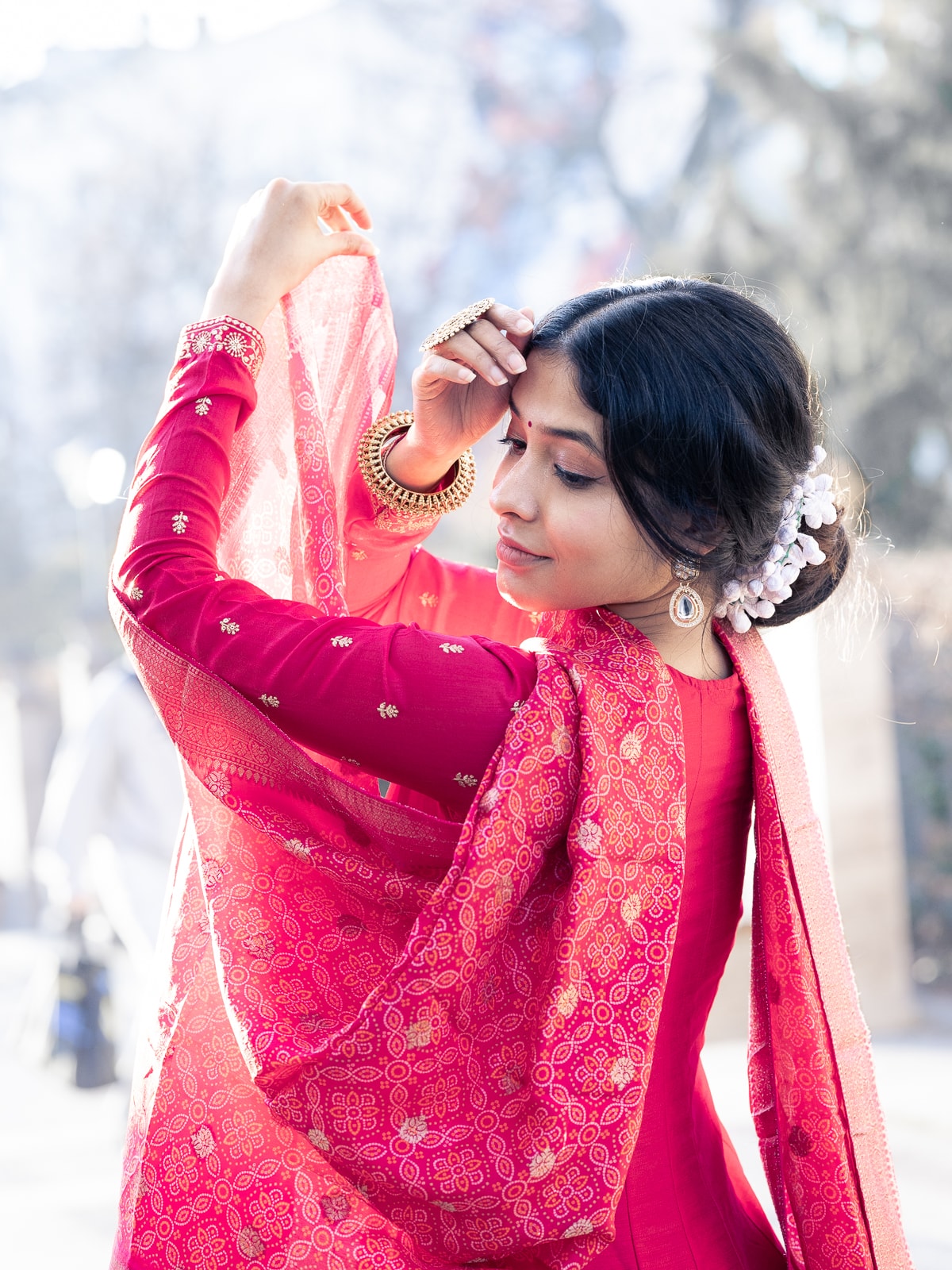 Indian bridal couple in romantic park scene with natural greenery