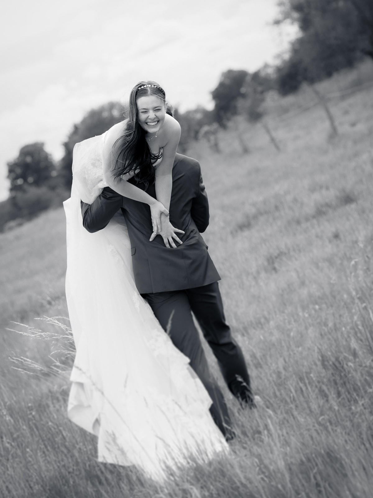 Joyful couple in playful motion on rural path