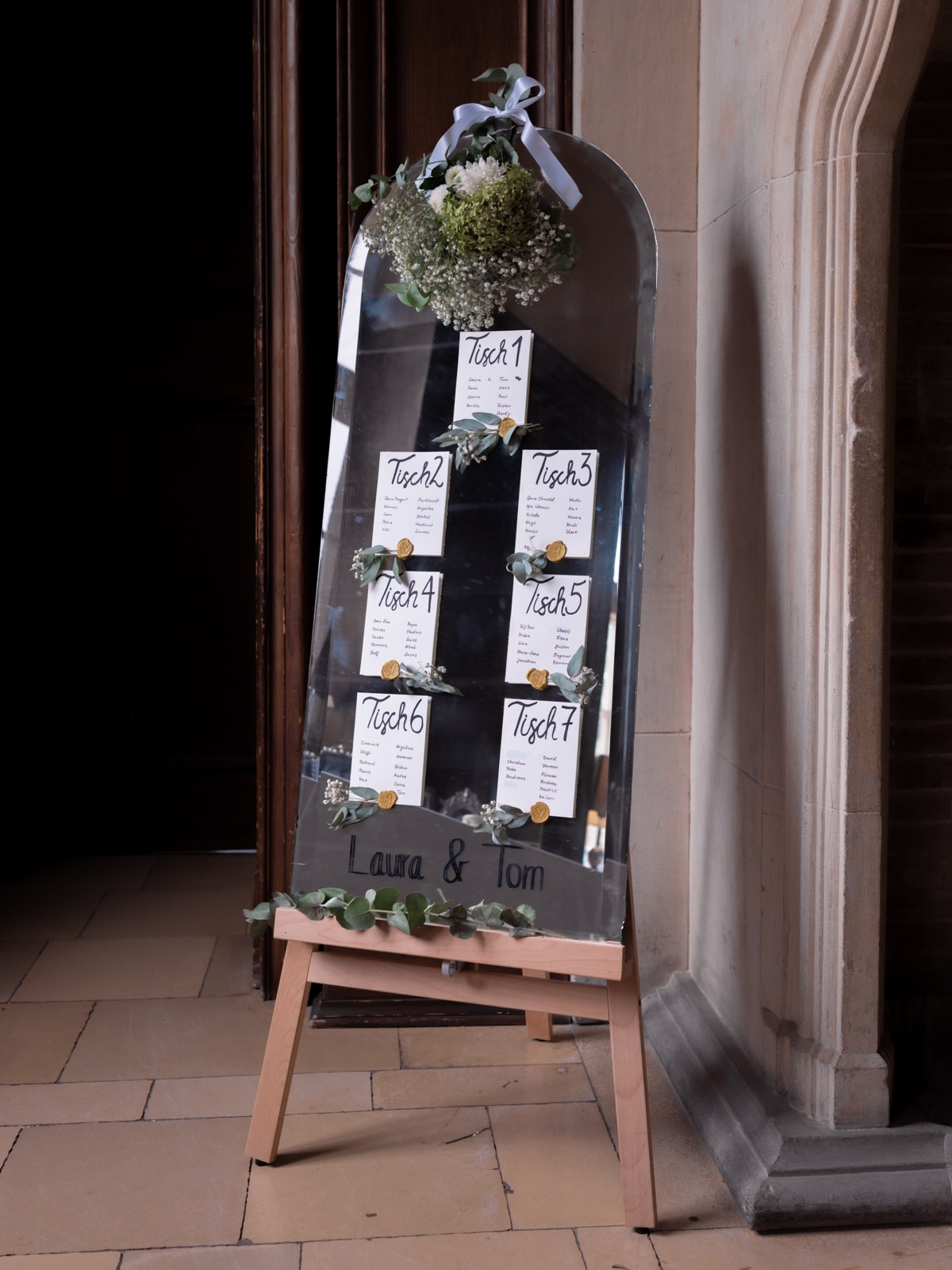 Mirror with seating chart table cards and floral decoration, wedding details Schloss Kartzow