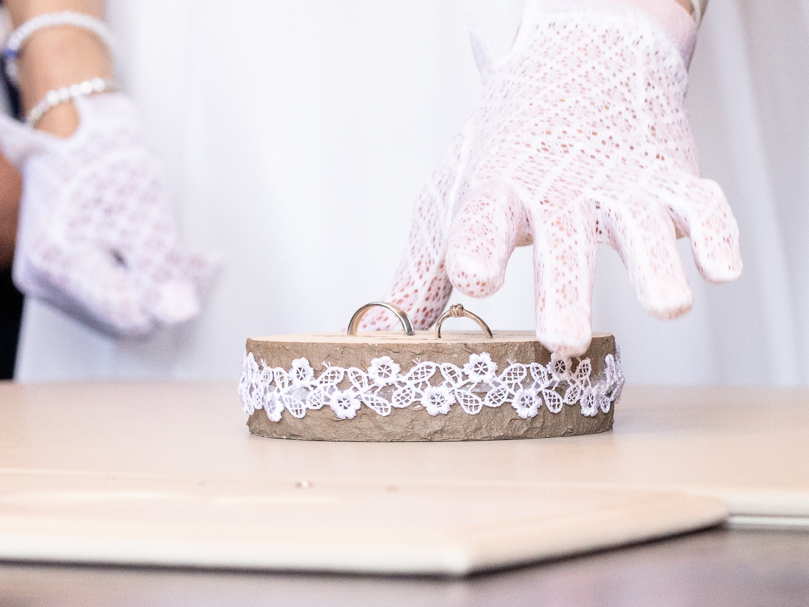 Wedding rings artistically arranged on wooden surface