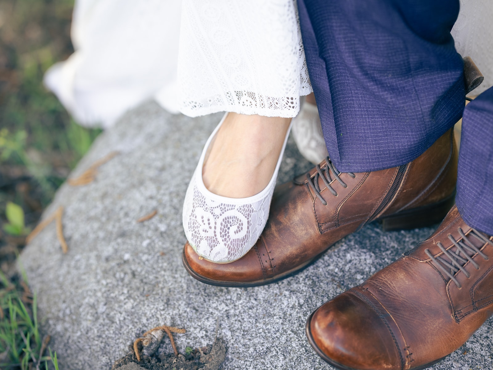 White lace ballet flats next to brown leather shoes