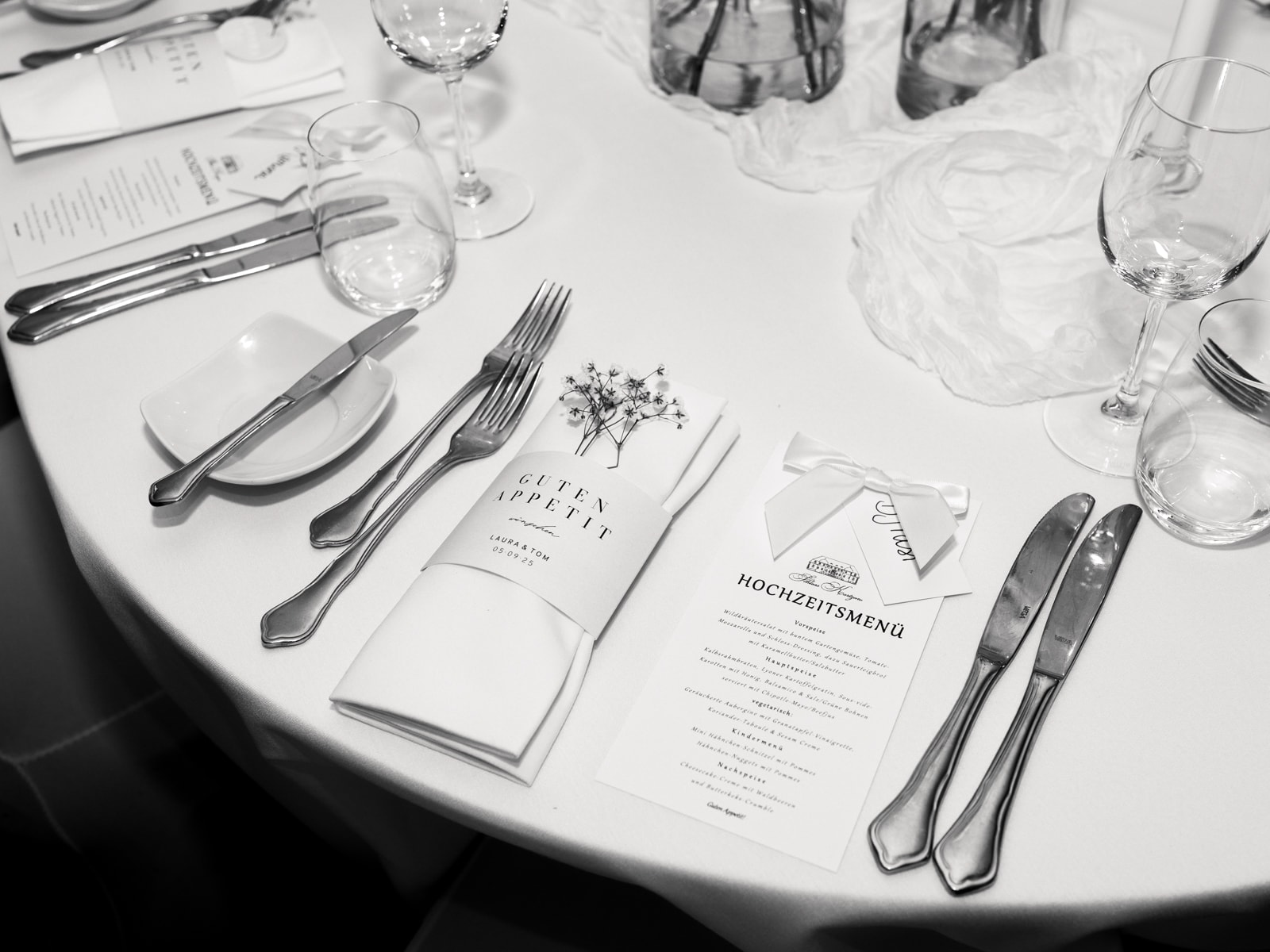 Set wedding table with menu card, cutlery and glasses at Schloss Kartzow wedding, black and white detail shot