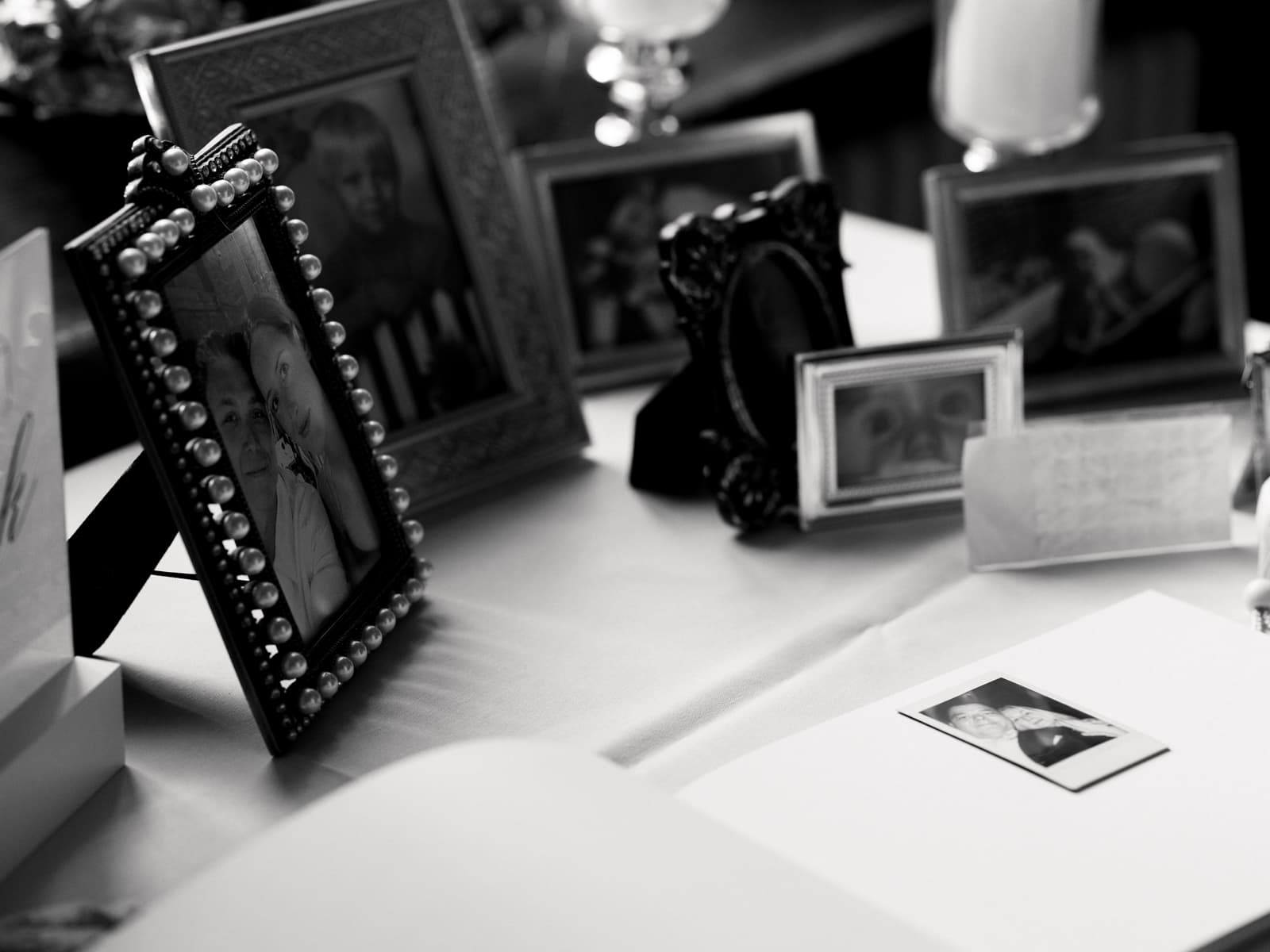 Vintage Bilderrahmen mit Familienfotos und Polaroid auf Tisch - Hochzeitsdetail Schloss Kartzow